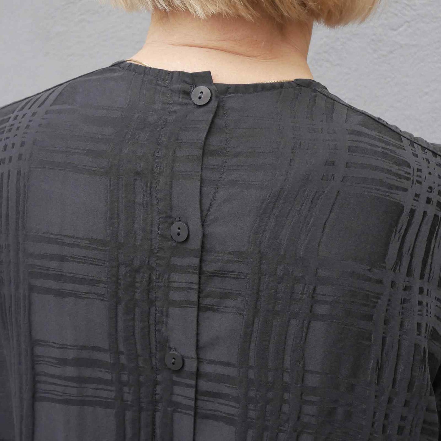 Knapper i ryggen på sort silke tunika fra Grizas