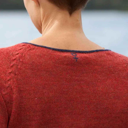 Kvindetegn i nakken på rød baby alpaca bluse