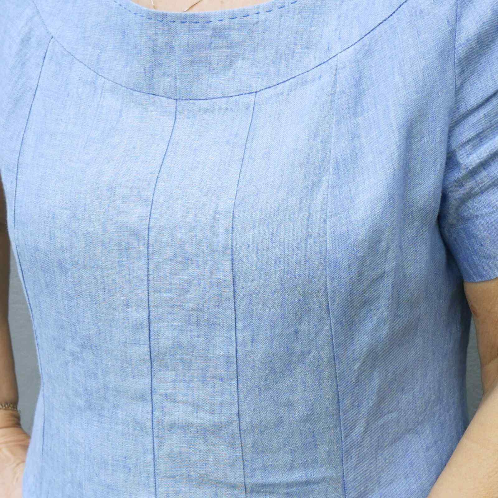 Nærbillede af syninger over brystet på lyseblå hørkjole